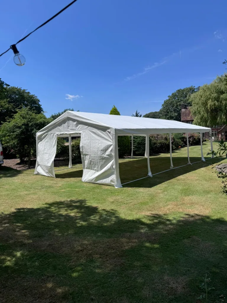 Long marquee with open sides set up on a lawn