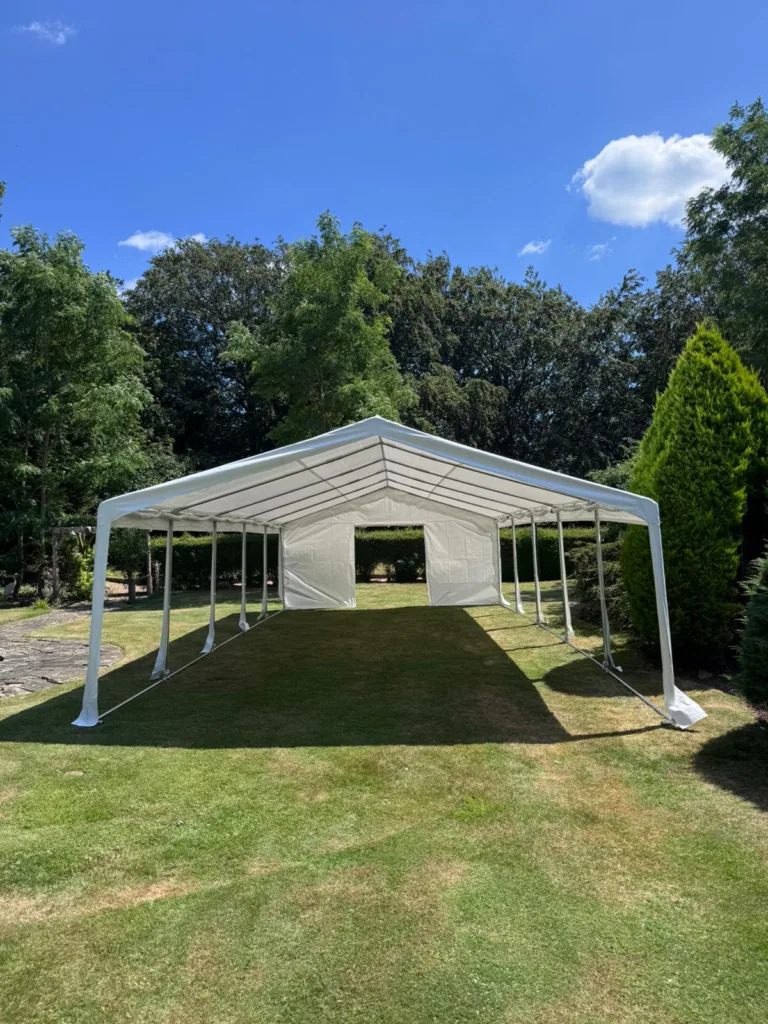 Marquee with open sides on a garden lawn in summer