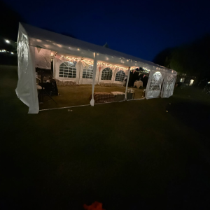 20m clear-span marquee with ivory lining and festoon lighting, set up for a wedding reception in Horsham
