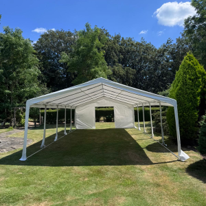 20m clear-span marquee with ivory lining and festoon lighting, set up for a wedding reception in Horsham
