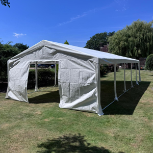 20m clear-span marquee with ivory lining and festoon lighting, set up for a wedding reception in Horsham